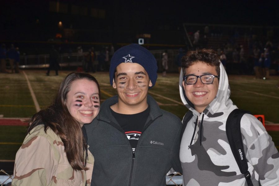 East students Rose Carani, Michael Severino, and Ghaika Vera smile at the big game against South