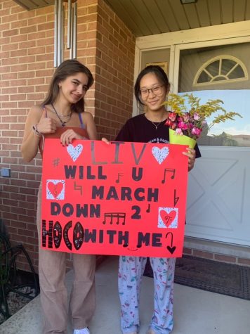 Carla Kosorog (left) asks Livia Lin (right) who is in the Marching Rams. 
