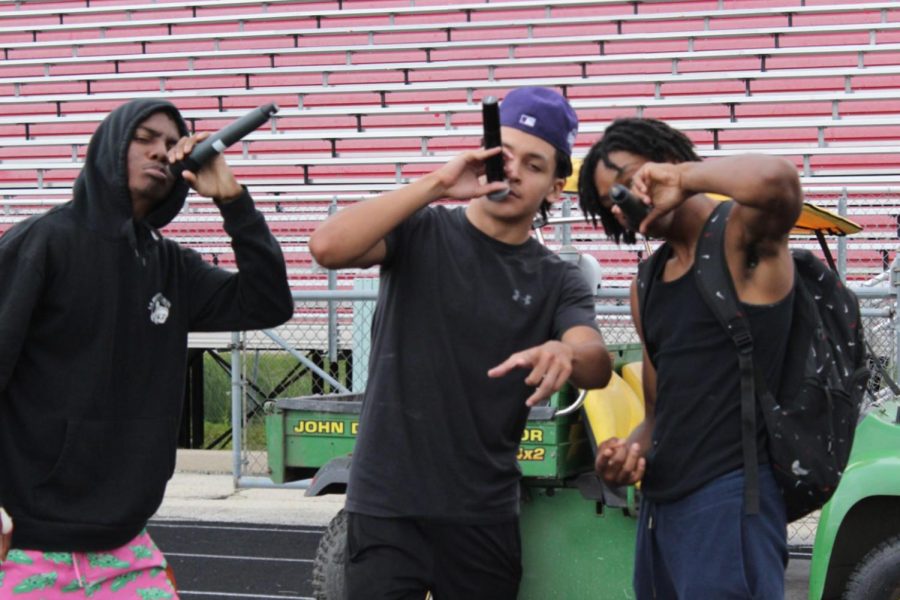 Flag football MCs Dailen Zollicoffer (left), Raul Garcia (center), and Kamron Manins (right) hype up the crowd, giving humorous updates throughout Friday’s flag football tournament. 

